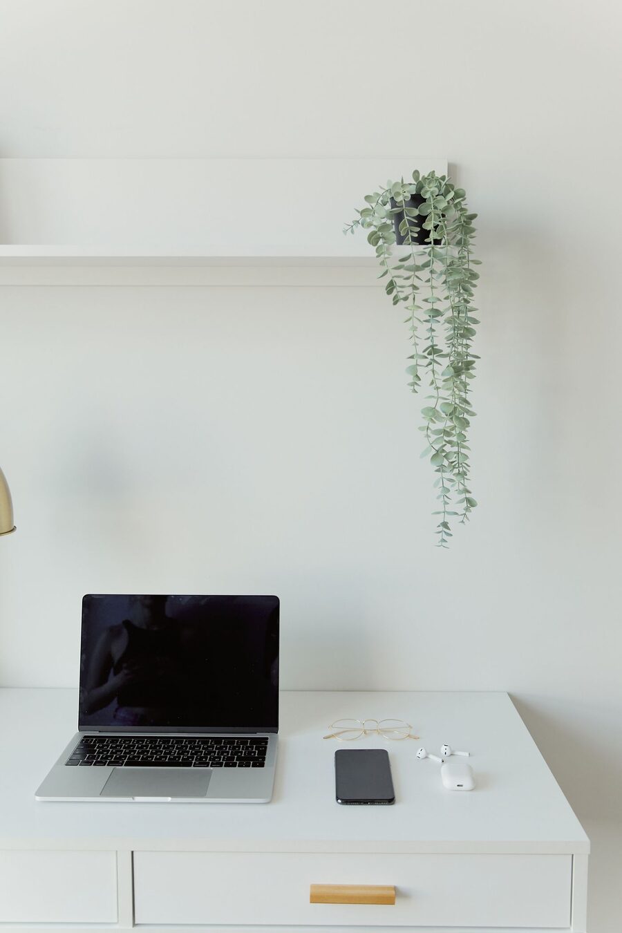A laptop and everyday devices on a desk at home